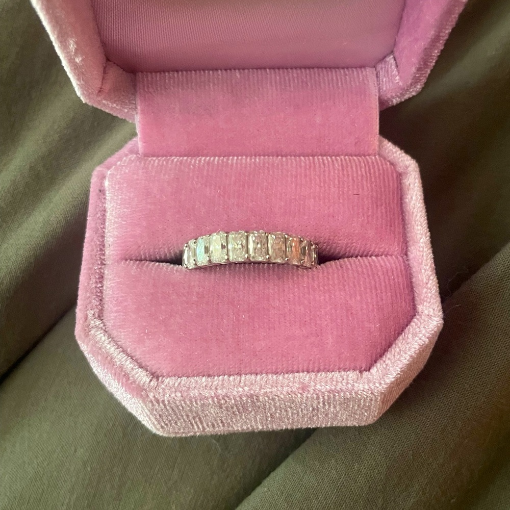 Lovely moissanite and 14k white gold radiant eternity band. Size 8.